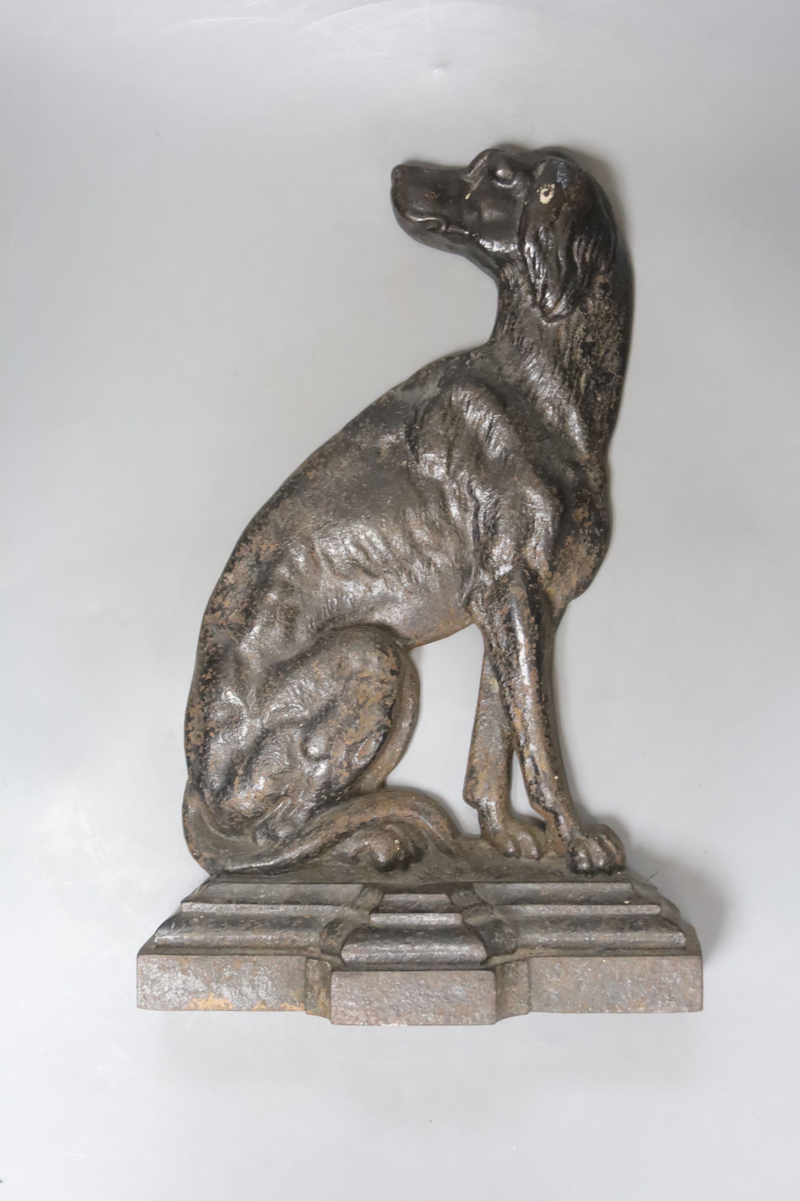 A Victorian Coalbrookdale style cast iron seated spaniel doorstop, registration mark, length 37cm